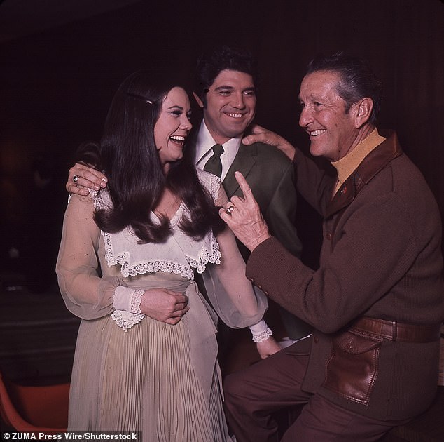 Singer Guy Hovis has died at age 84 after battling an illness in the hospital; Hovis pictured center with then-wife Ralna English and Lawrence Welk  - pictured 1960s