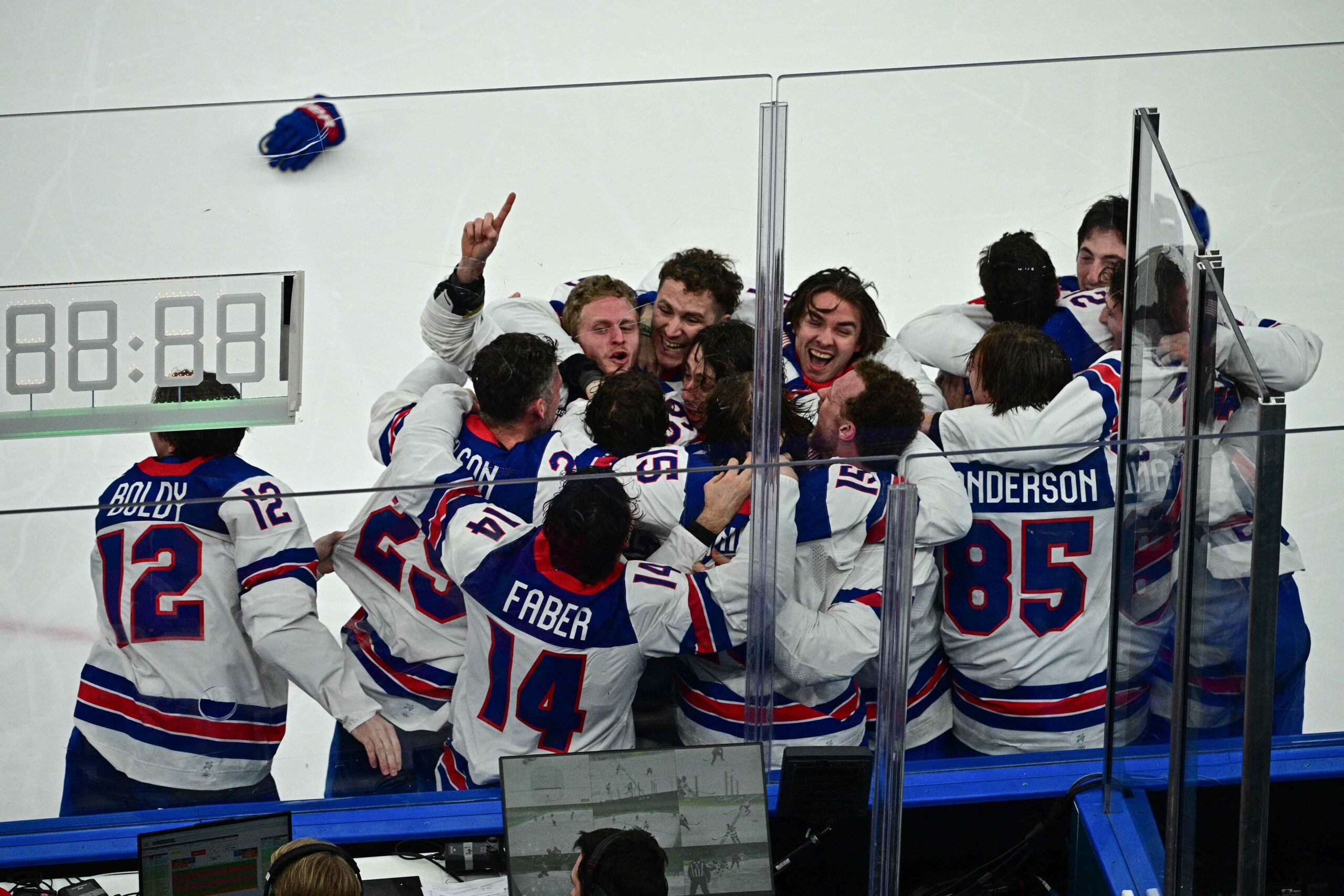 USA's players celebrate after winning gold at the 2026 Winter Olympics JULIEN DE ROSA / AFP via Getty