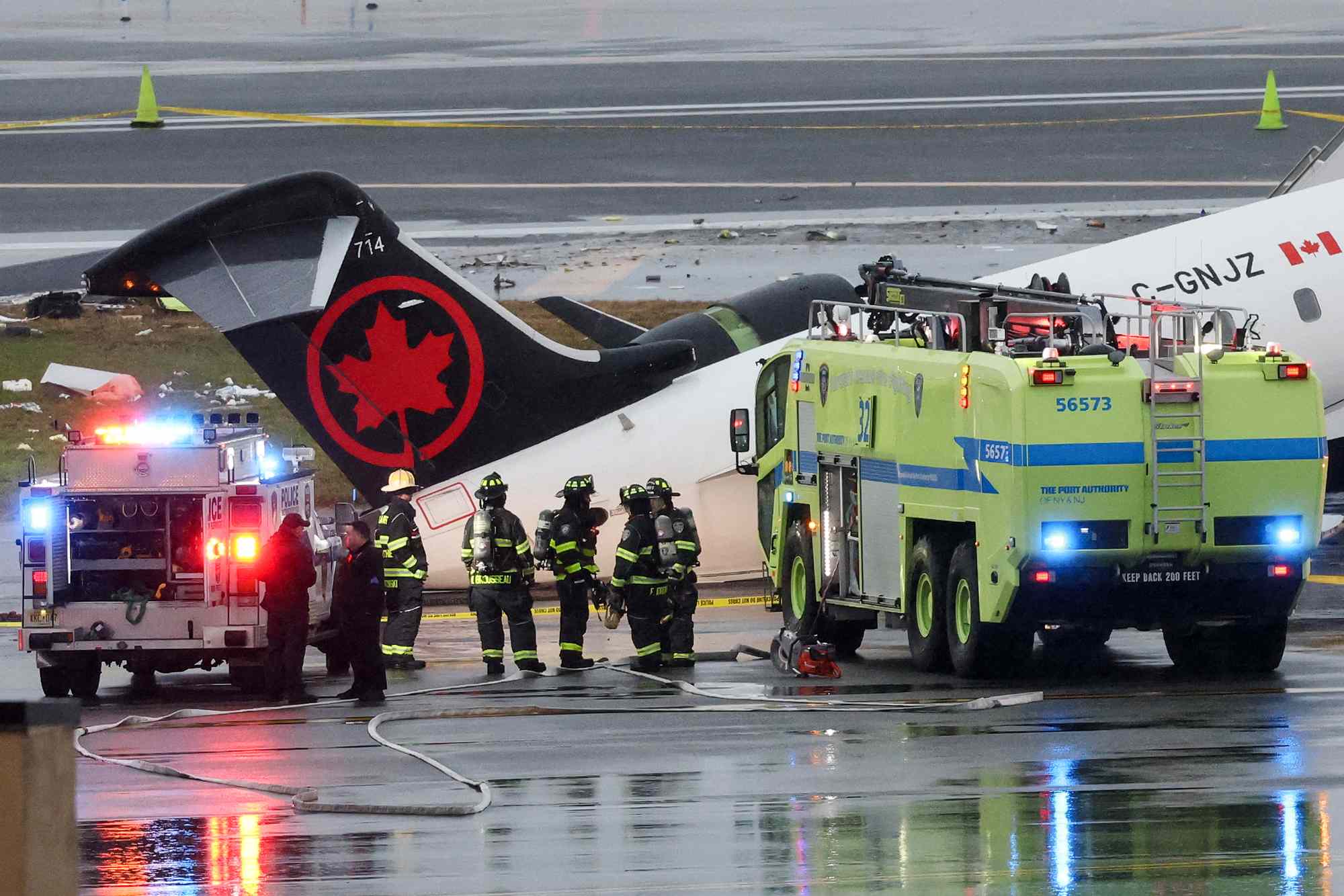 First responders at the scene of the fatal plane crash at New York's LaGuardia Airport on March 23.Credit: TIMOTHY A. CLARY / AFP via Getty