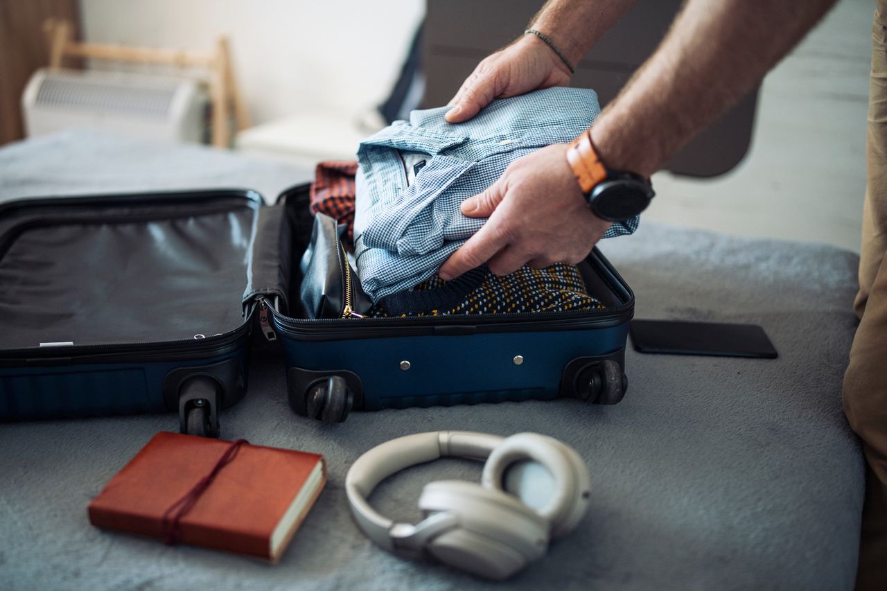 Stock image of a person putting clothes in their suitcaseCredit: Getty