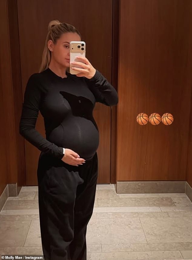 Pregnant Molly-Mae Hague, 26, showed off her growing bump in a tight black top as she shared a series of Instagram snaps on Wednesday