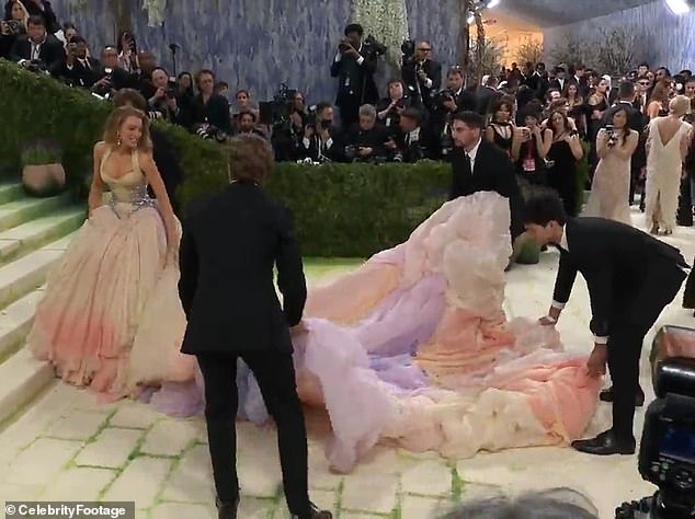 Blake Lively raised eyebrows on Monday's Met Gala red carpet after she appeared to share some stern words with the helpers assisting in lugging around her dress's massive train