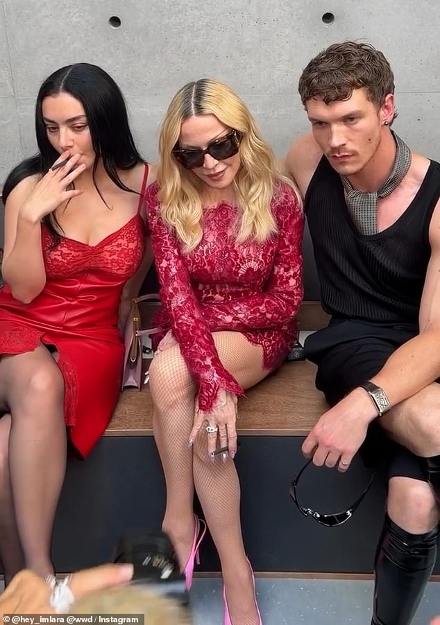 Madonna and Charli XCX smoked cigarettes on the front row at Saint Laurent Men's Paris Fashion Week show on Tuesday following rumours of a feud brewing