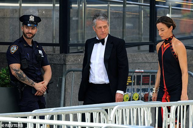 Why was Hugh Grant at Taylor Swift's wedding? Stars' unexpected friendship revealed after fans were baffled by his appearance at singer's nuptials (pictured arriving at MSG with wife Anna Eberstein on Friday)